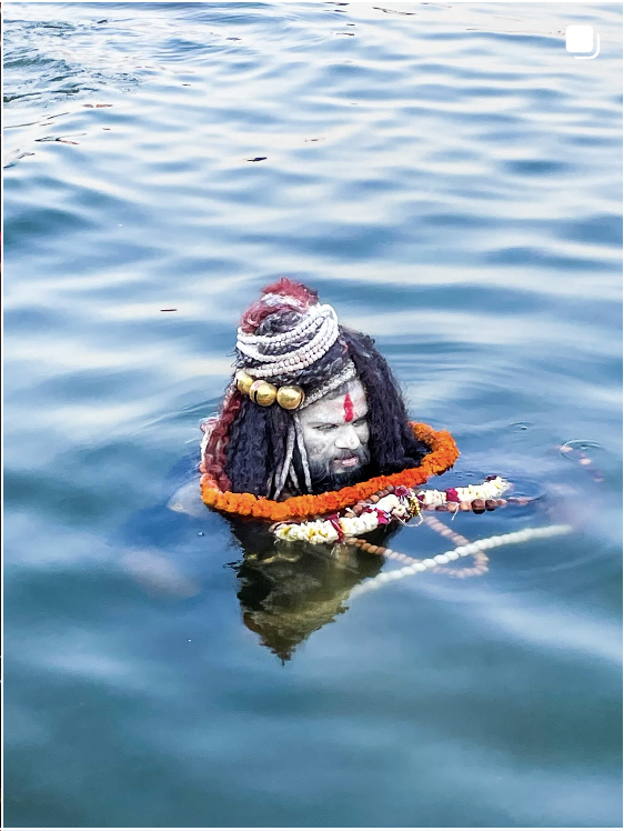 Varanasi, India: Devotion floating on still water